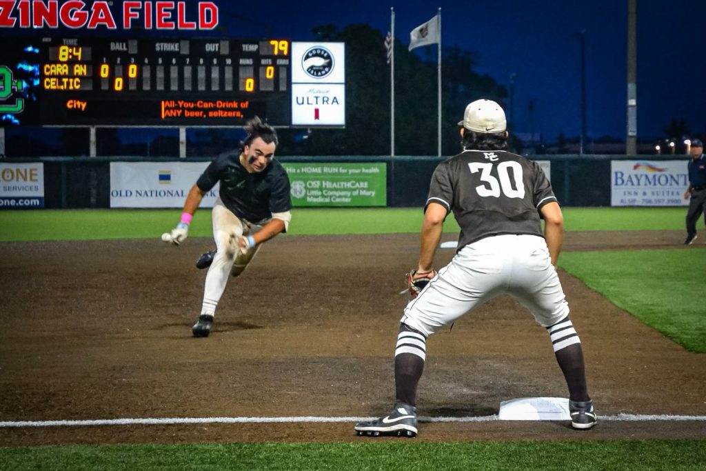 Providence's Enzo Infelise dives into third for an RBI triple with Pancho Vazquez ready to field the throw. Photo by Xavier Sanchez
