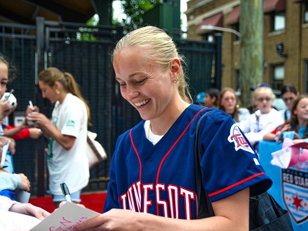 Chicago Red Stars player Penelope Hocking signs autographs before the team's match against Bay FC on June 8 at Wrigley Field. Photo by Xavier Sanchez