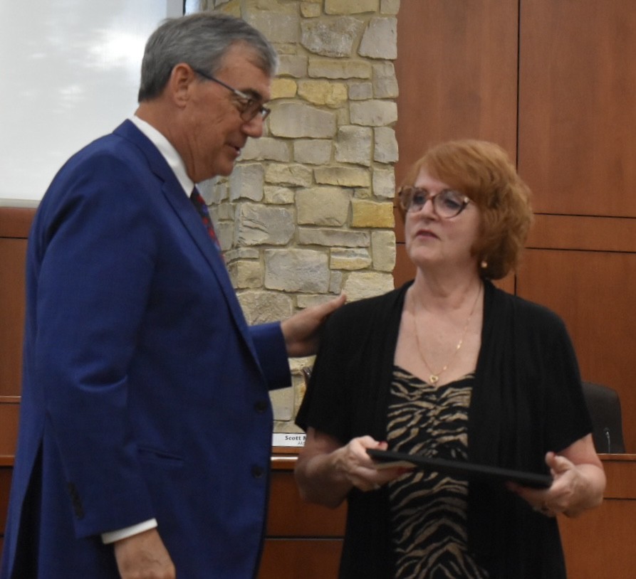 Tina Grotzke chats with Countryside Mayor Sean McDermott after he presented her a certificate of appreciation for her 20 years on the zoning board. (Photo by Steve Metsch)